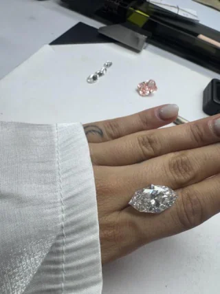 A marquise cut diamond on the hand at a sorting table